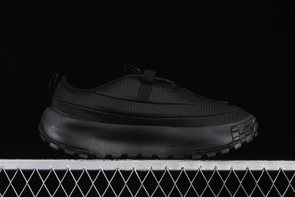 Side profile of the black low-top shoe