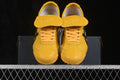 Front view of yellow Onitsuka Tiger sneakers with black accents and branded tongue flaps