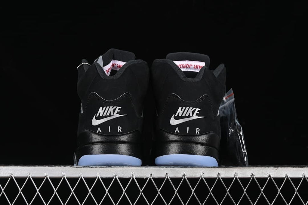 Rear view of both shoes showing Nike Air heel branding