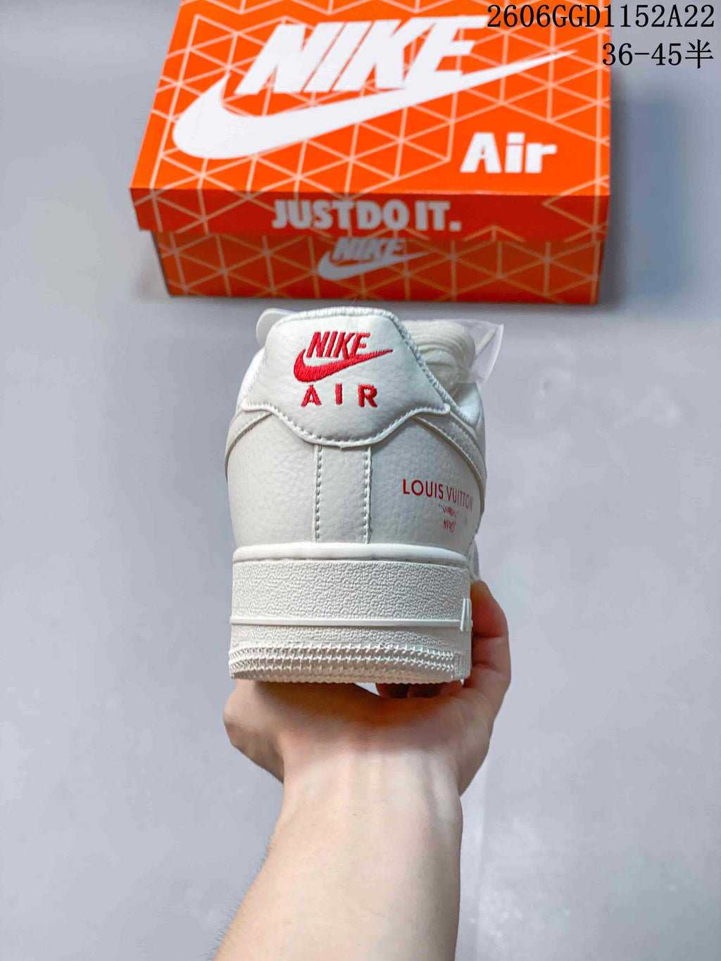 Rear view of the white sneaker with red heel lettering