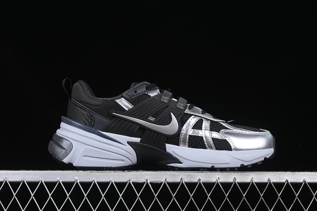 Side profile of a black and silver low-top shoe with a white sole