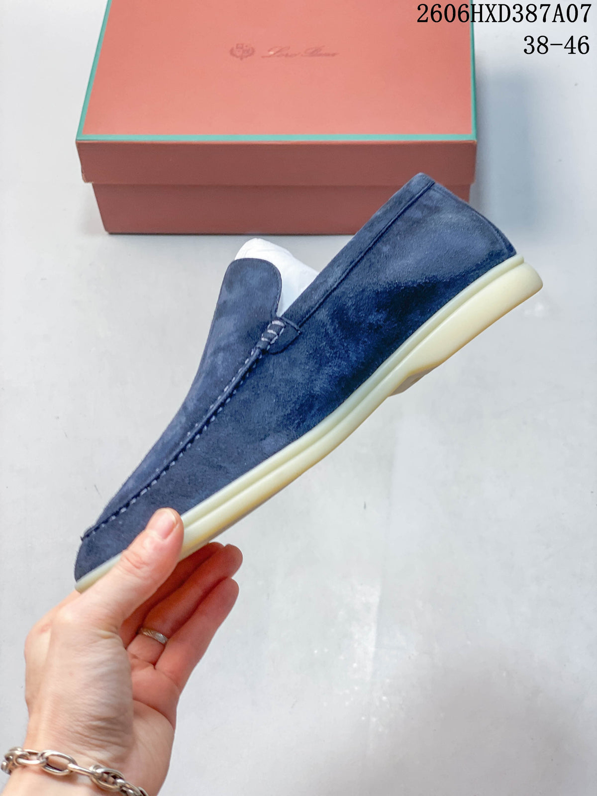 Side profile of a blue slip-on loafer with moc-toe stitching and a light-colored sole.