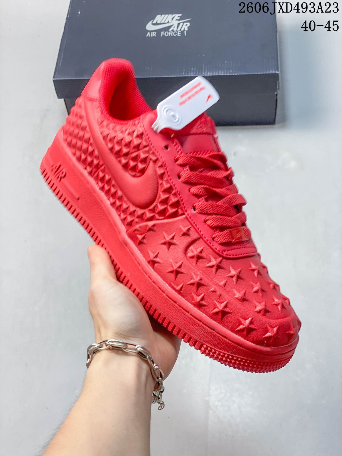 Close view of a red star-textured sneaker with matching laces
