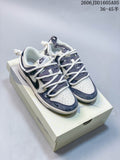 Pair of white, navy, and gray Nike SB Dunk Low sneakers on a box