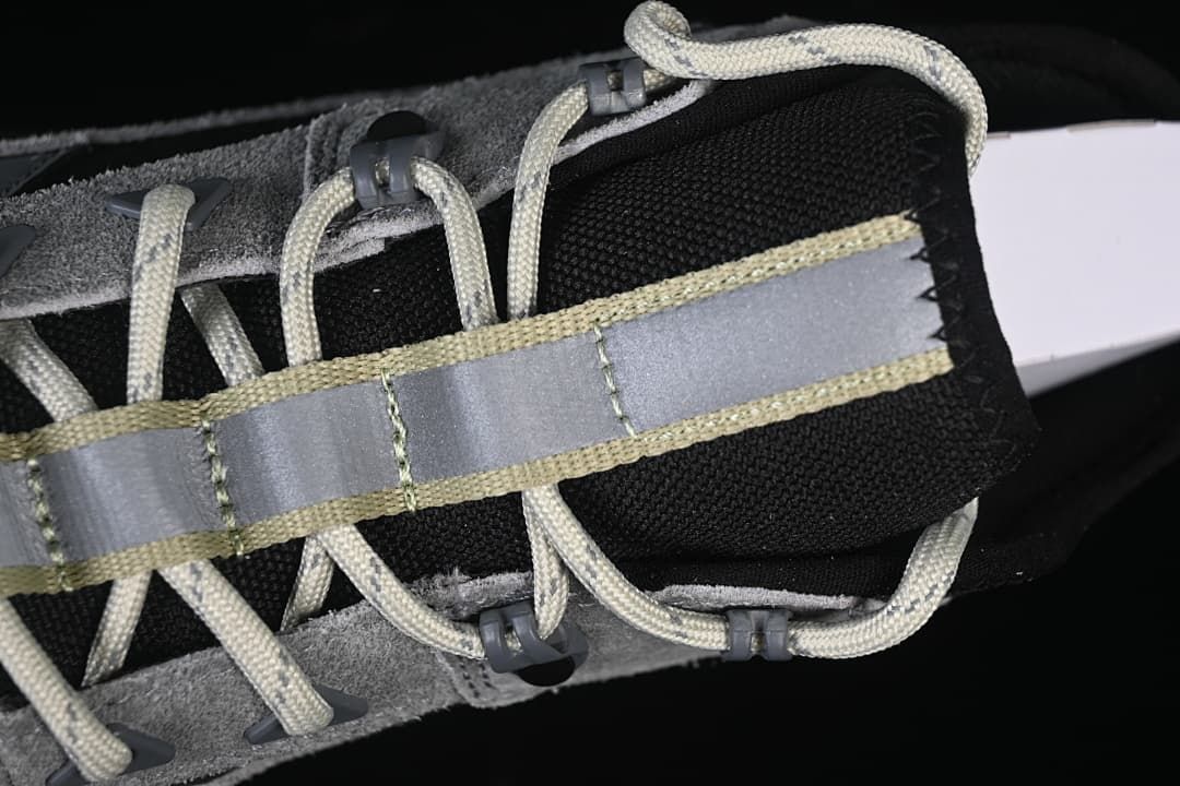 Close-up of the lace area, tongue, and reflective-looking central strip.