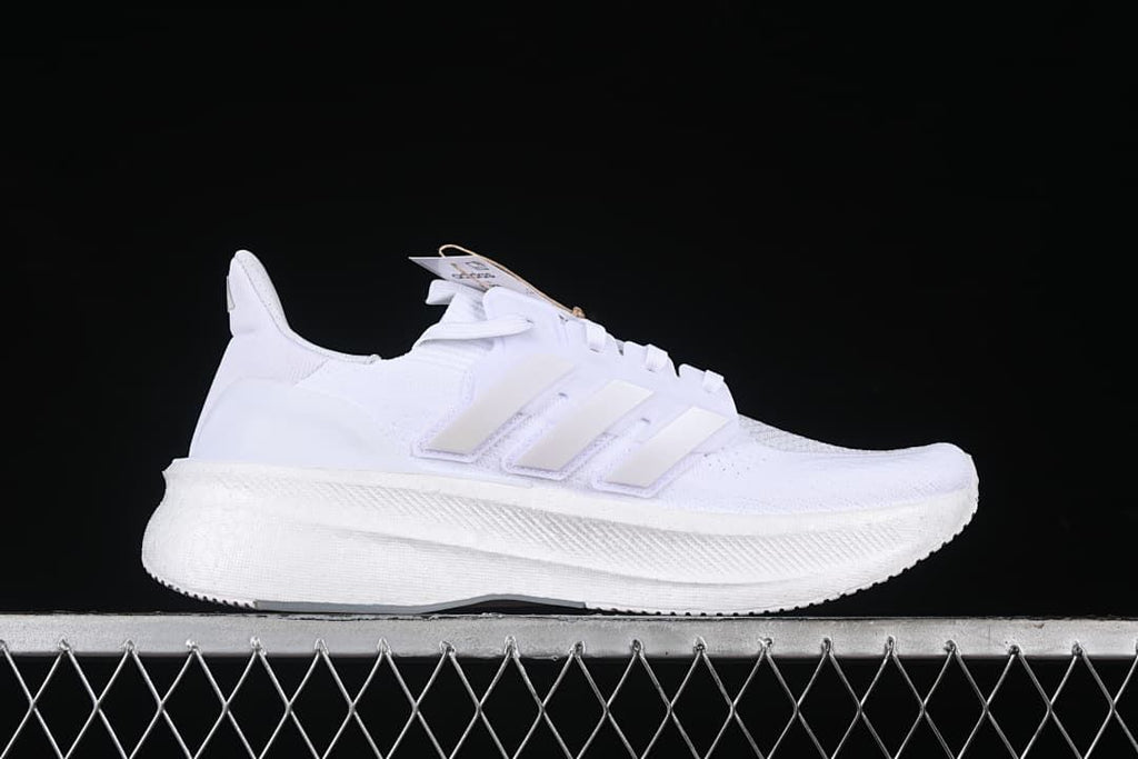 Side profile of a white Adidas Ultraboost 5 shoe.