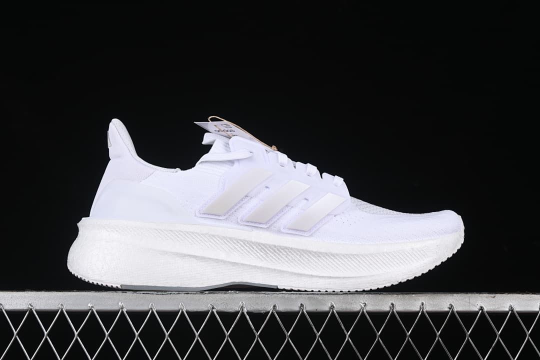 Side profile of a white Adidas Ultraboost 5 shoe.