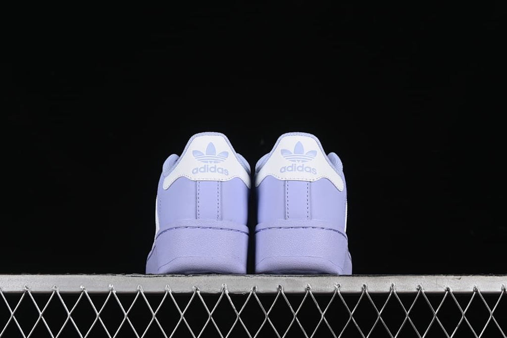 Rear view of both sneakers showing heel tabs and platform-style soles