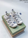 Pair of white and gray Keen Astoria West sandals with blue accents and gum-colored outsoles