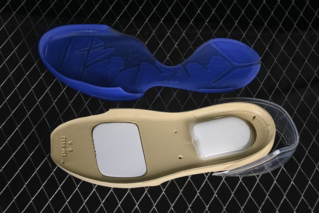 View of the blue outsole and a shoe insert.
