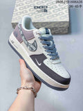 White and gray low-top sneaker with patterned dark Swoosh and pale blue-gray accents