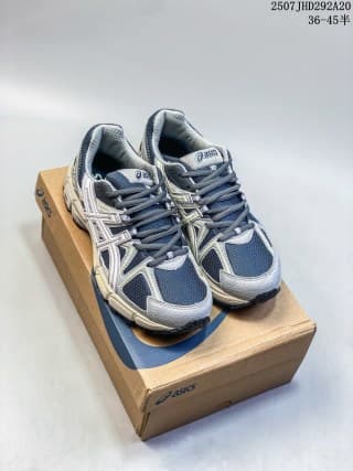 Pair of navy, gray, and white ASICS Gel-Kahana 8 sneakers displayed on an ASICS shoe box.