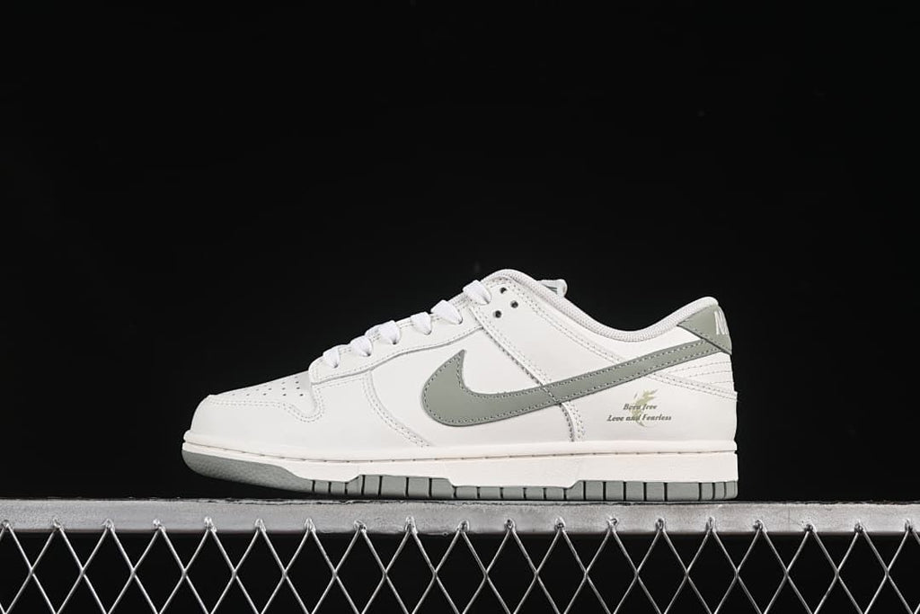 Side profile of the white and grey-green Nike SB Dunk Low