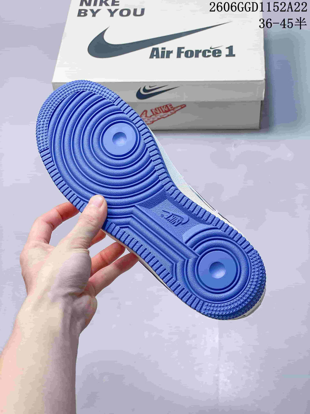 Blue outsole of a white Air Force 1 sneaker