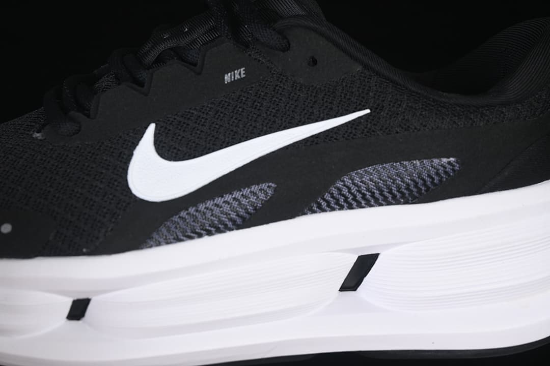 Close-up of the white Swoosh, black upper, and white midsole.