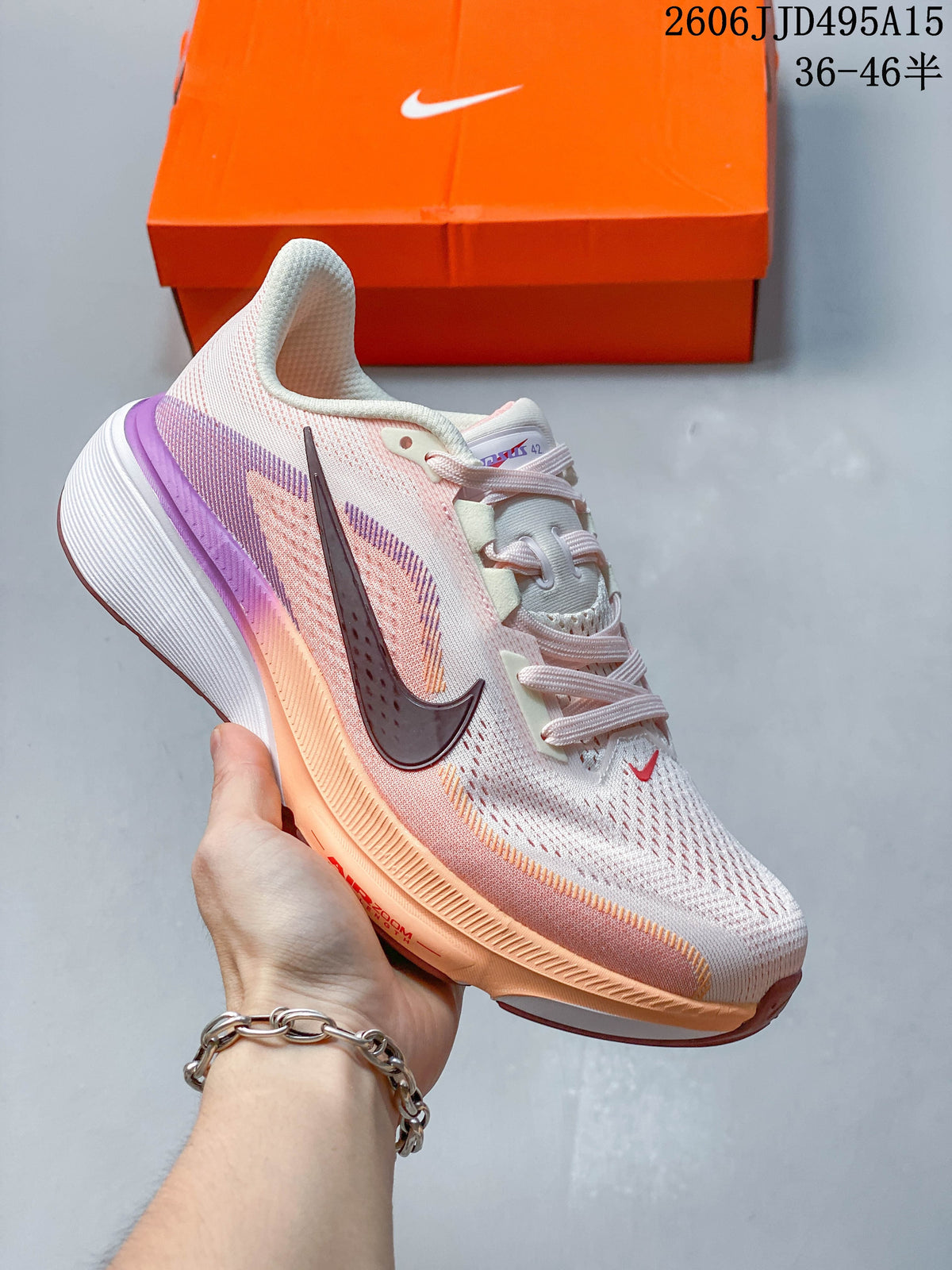 Pale pink Nike Air Zoom Pegasus 42 shoe with lavender and peach accents