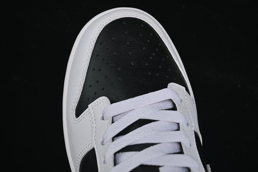 Top-down close-up of the perforated black toe and white laces