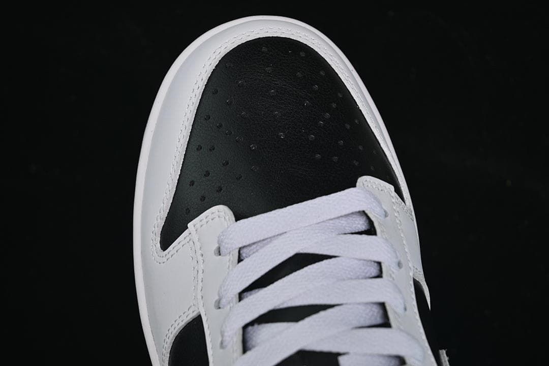 Top-down close-up of the perforated black toe and white laces