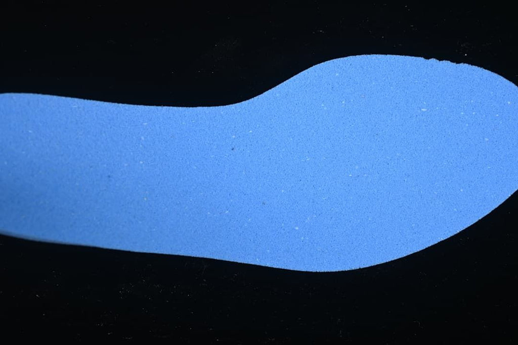 Blue shoe-shaped insert or material piece shown against a dark background.