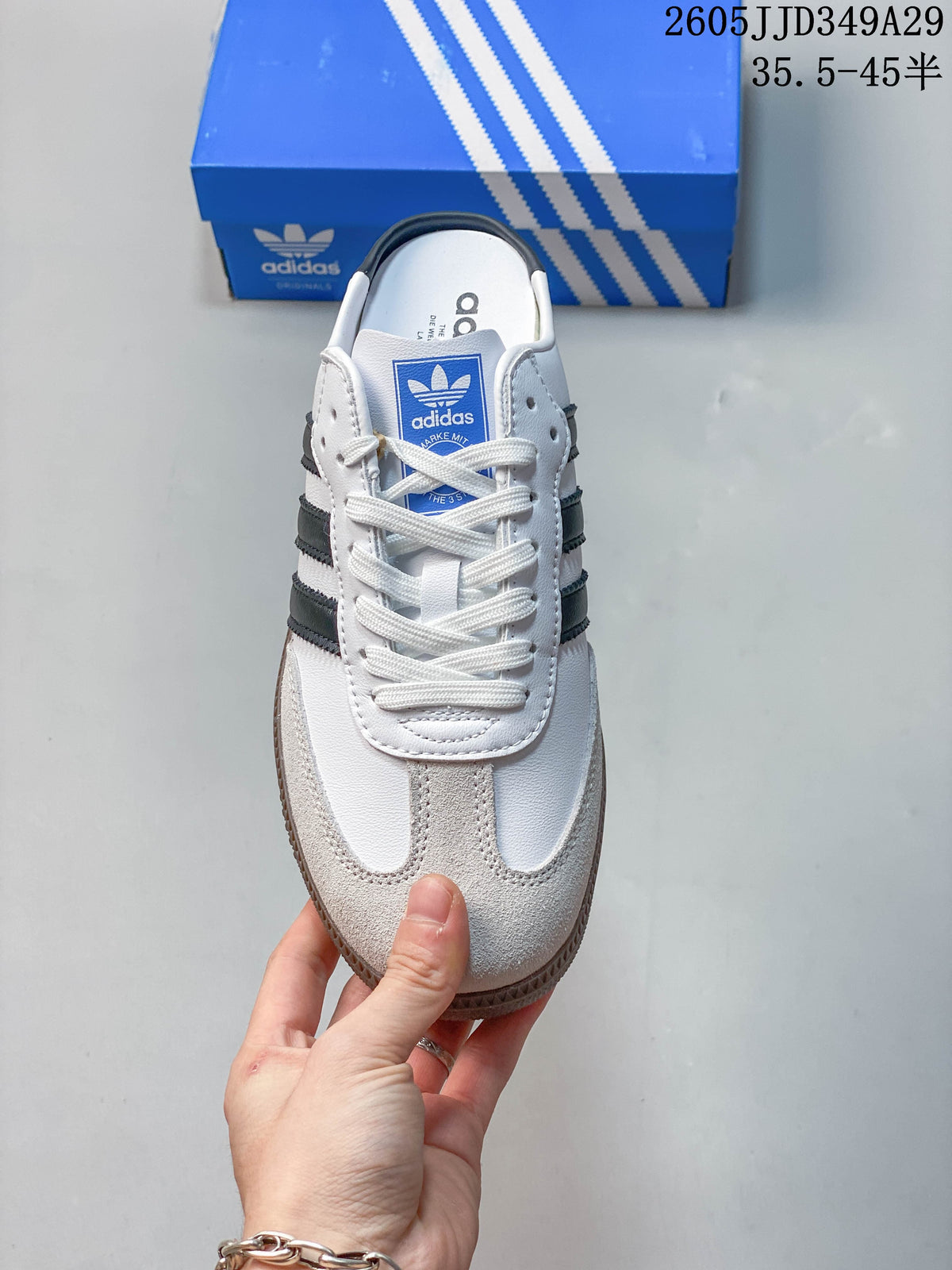 Top view of the mule sneaker showing white laces and a light-colored toe overlay.