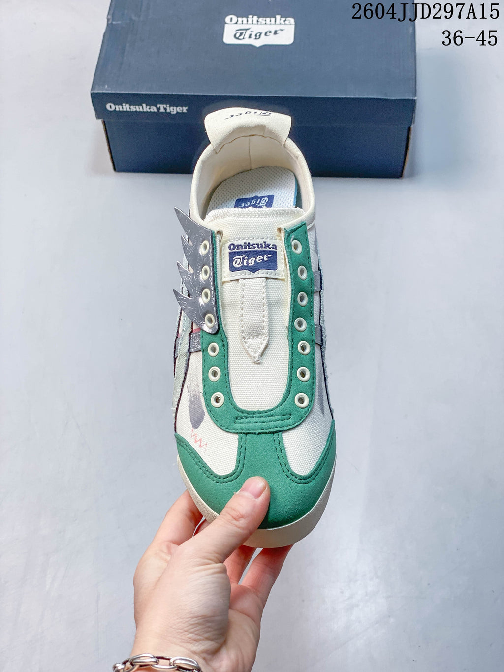 Top view of the slip-on sneaker with green toe detailing and lace eyelets