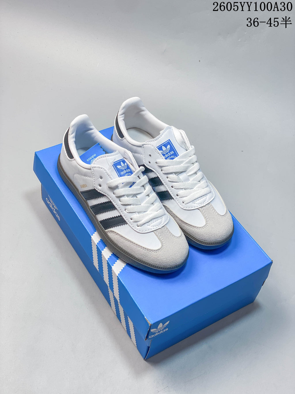 White Adidas Samba OG sneakers with dark side stripes and a gum-look outsole