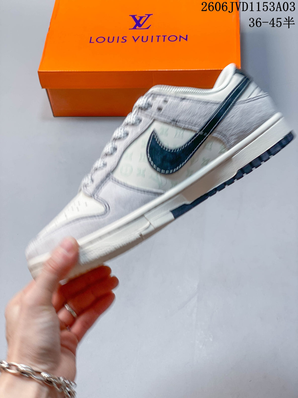Side view of a white and grey low-top sneaker with a dark Swoosh and patterned panel