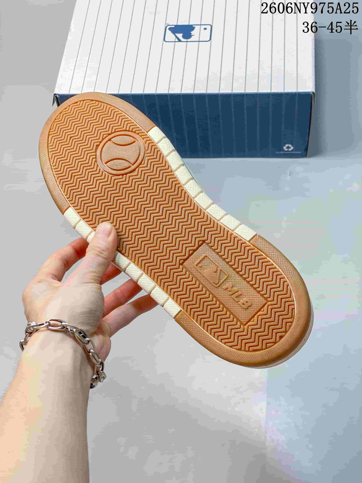 Close-up of the gum-colored outsole with a repeating zigzag tread pattern.