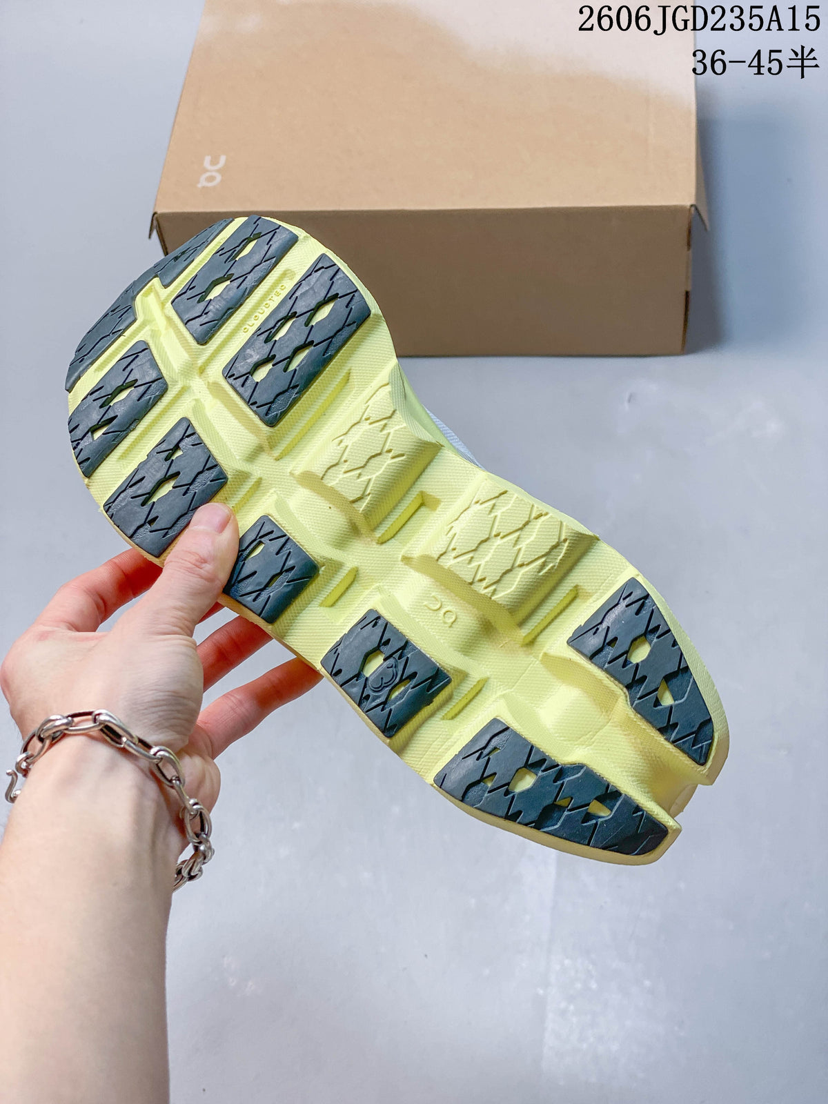 Outsole view of the On running shoe, showing pale yellow sections and dark gray tread