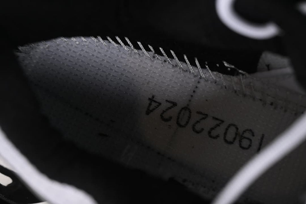 Close-up inside the shoe showing a printed production code.