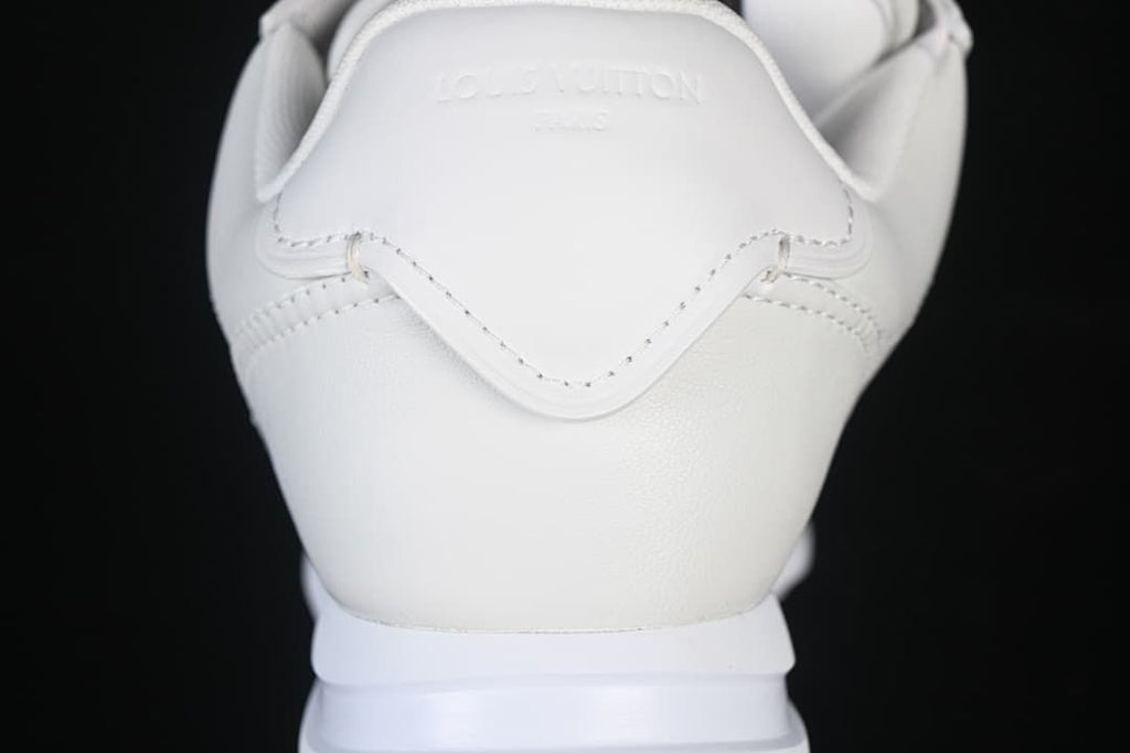 Close-up of the white heel and stitched panels