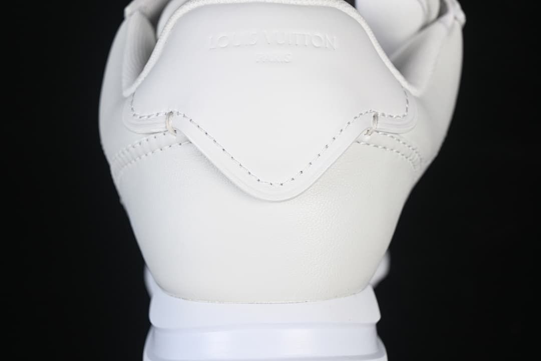 Close-up of the white heel and stitched panels