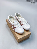White low-top lace-up sneakers with brown side stripes, shown on a shoe box