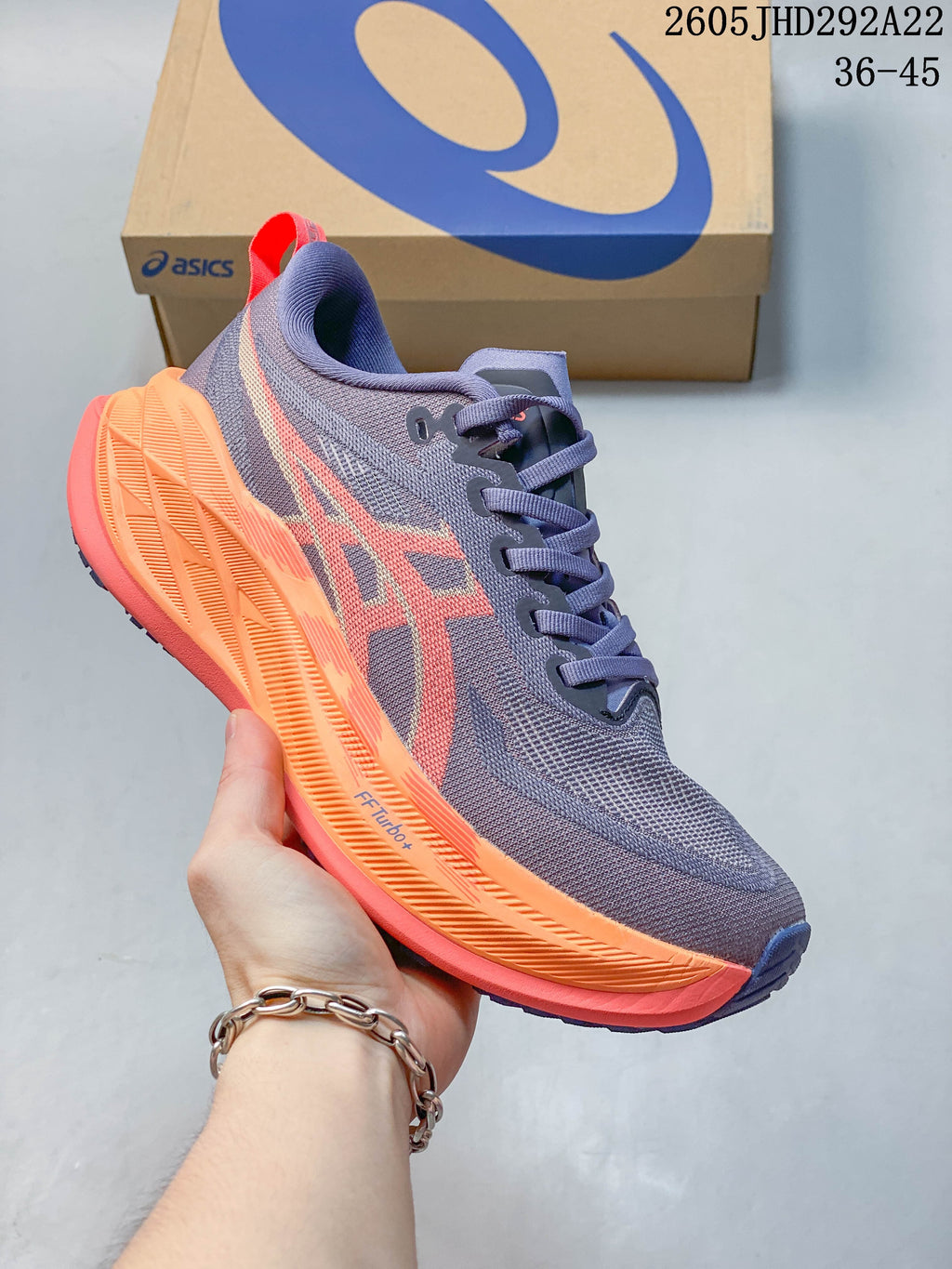 Purple and coral ASICS Superblast 2 Paris running shoe with lace-up closure and sculpted midsole.