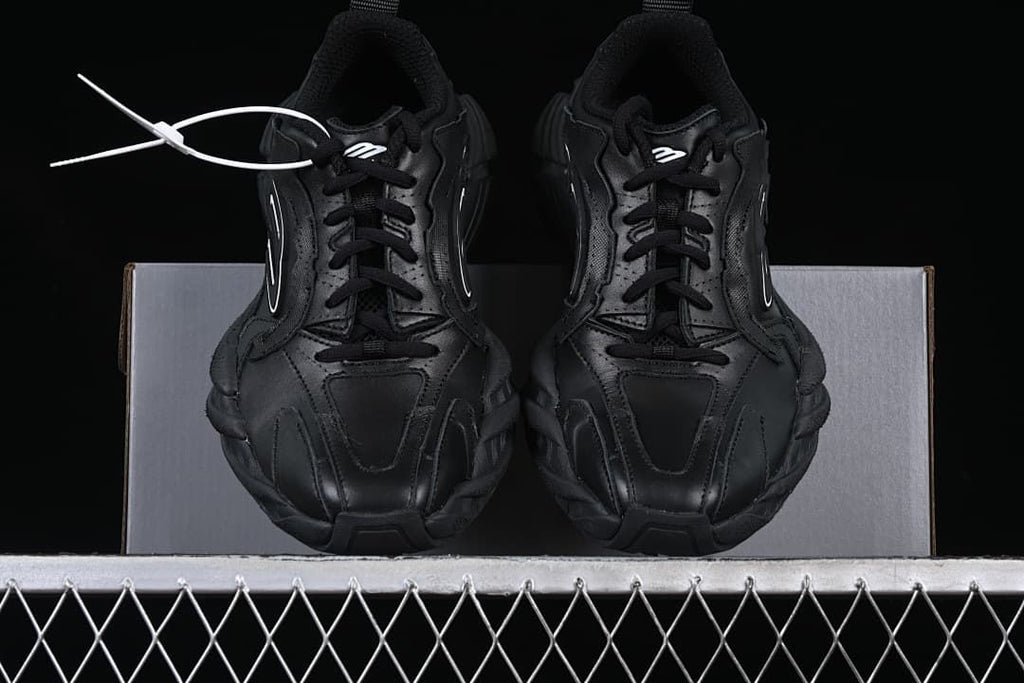 Front view of the pair of black lace-up sneakers