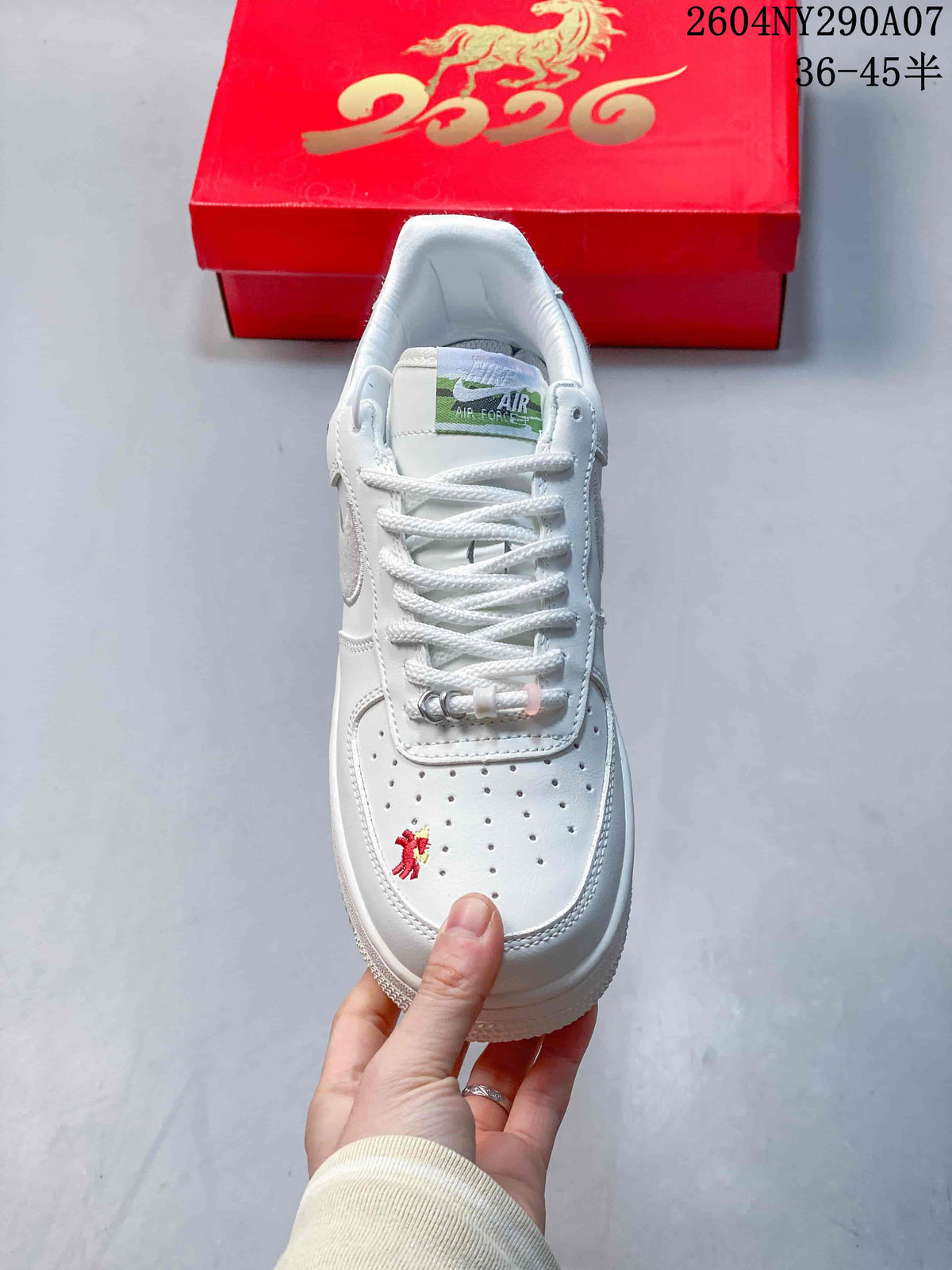 Top view showing white laces, perforated toe panel, and embroidered detail.