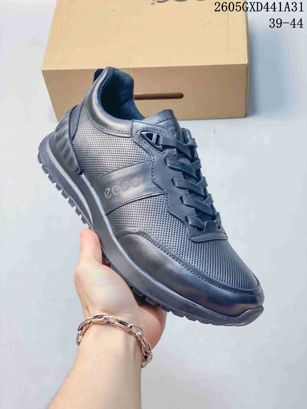 Angled side view of the navy sneaker showing its perforated panels and ECCO branding