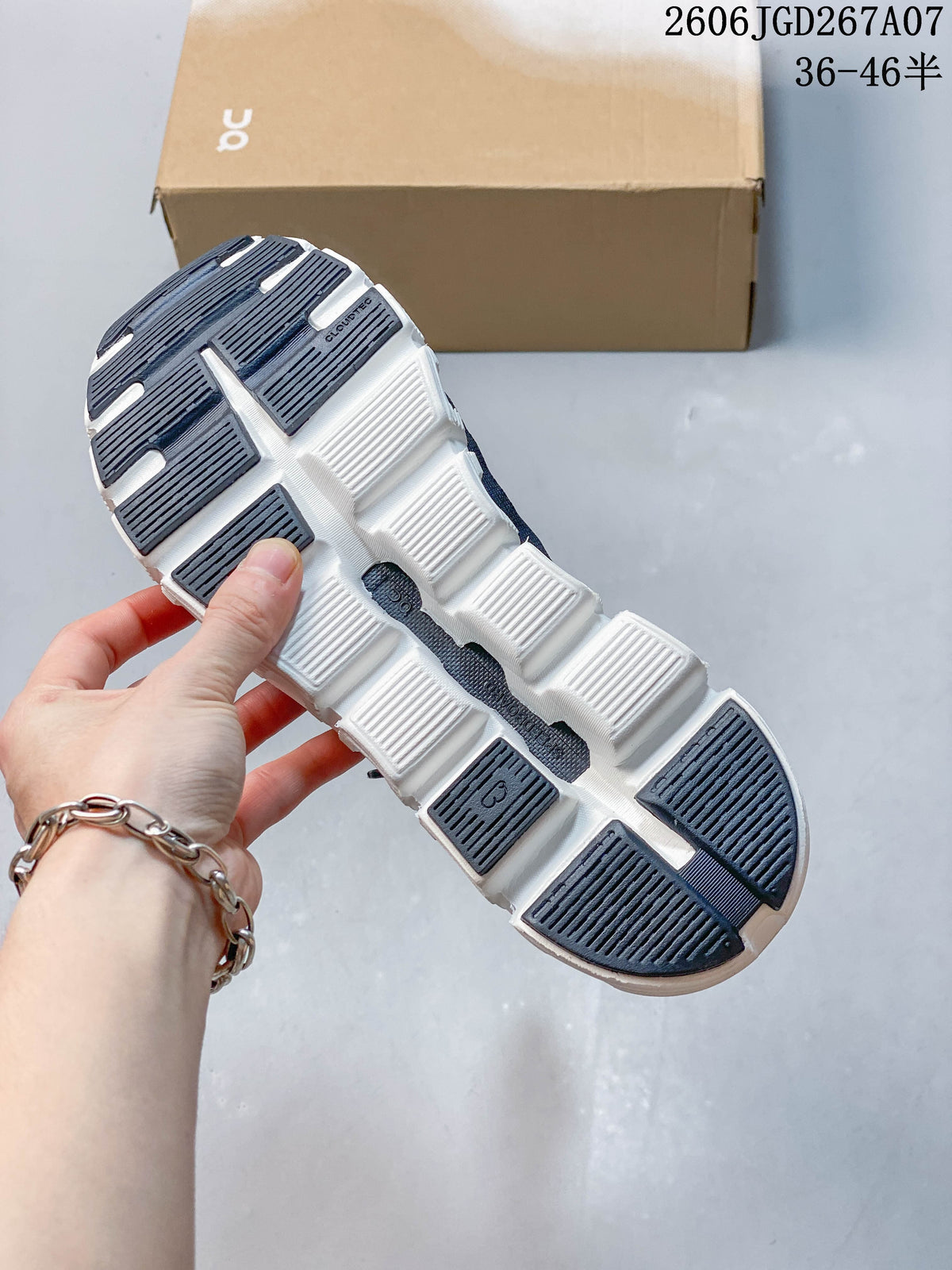 Underside of the shoe showing a white outsole with dark traction sections.