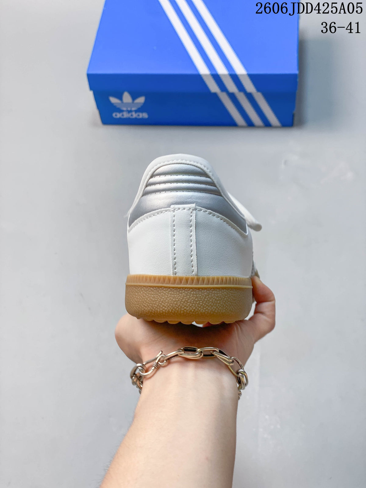 Rear view of the white sneaker with a gum-colored outsole