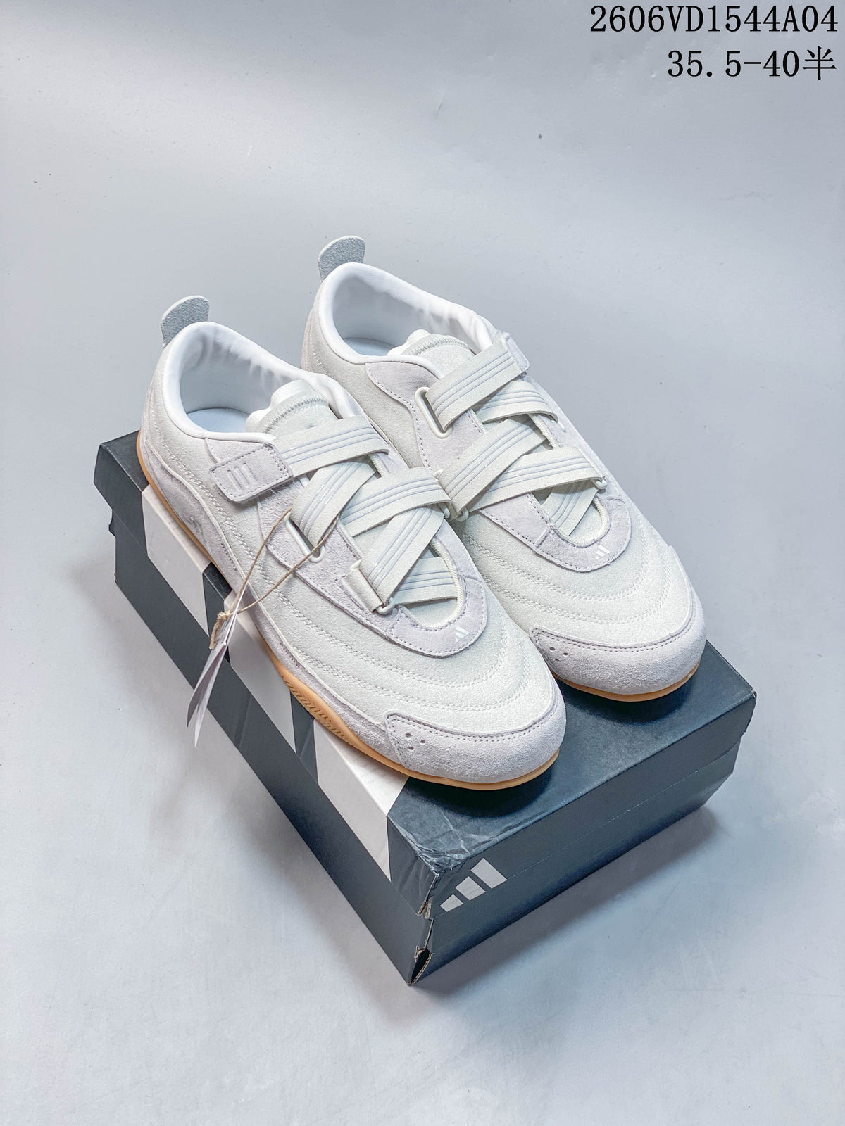 Light gray and off-white adidas Urban Reverie low-top sneakers with crossover straps and gum-colored soles