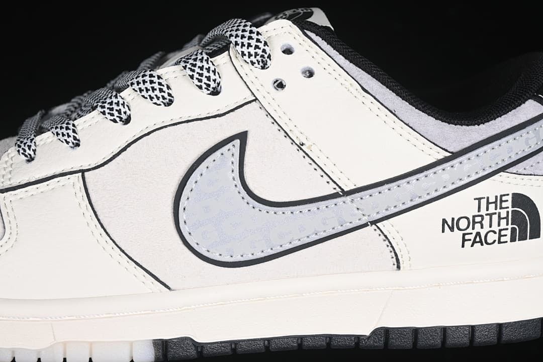 Close-up of patterned laces, grey patterned Swoosh, and The North Face side branding