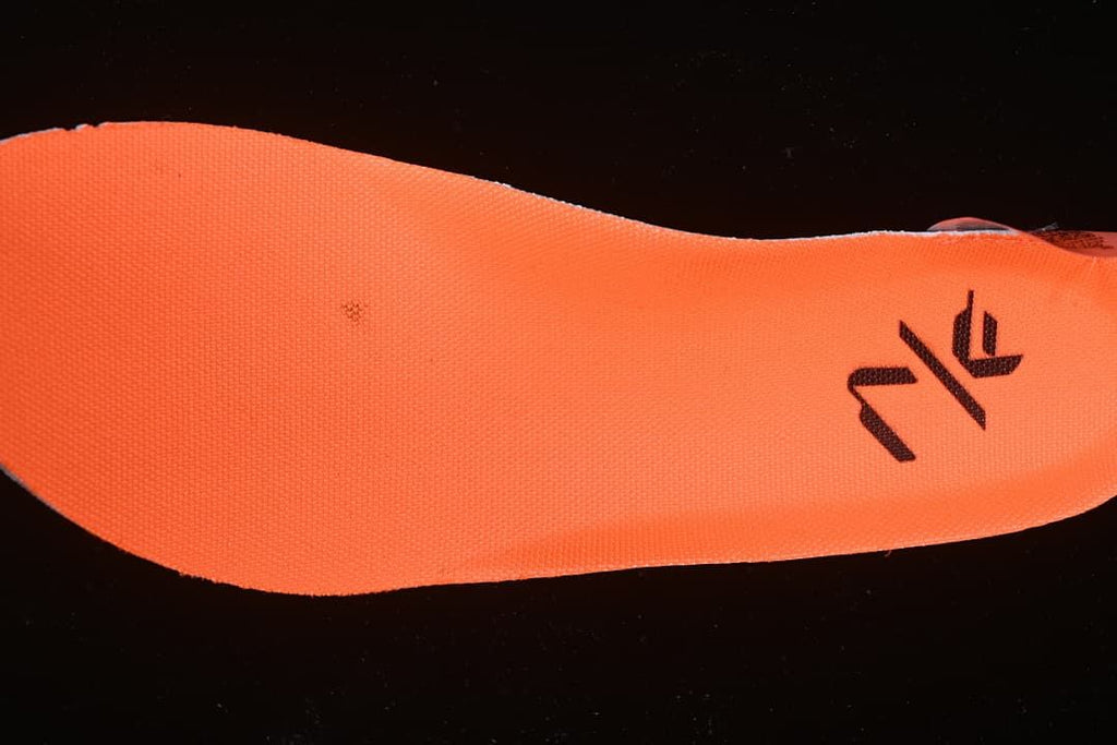 Close-up of a bright orange insole with a black graphic