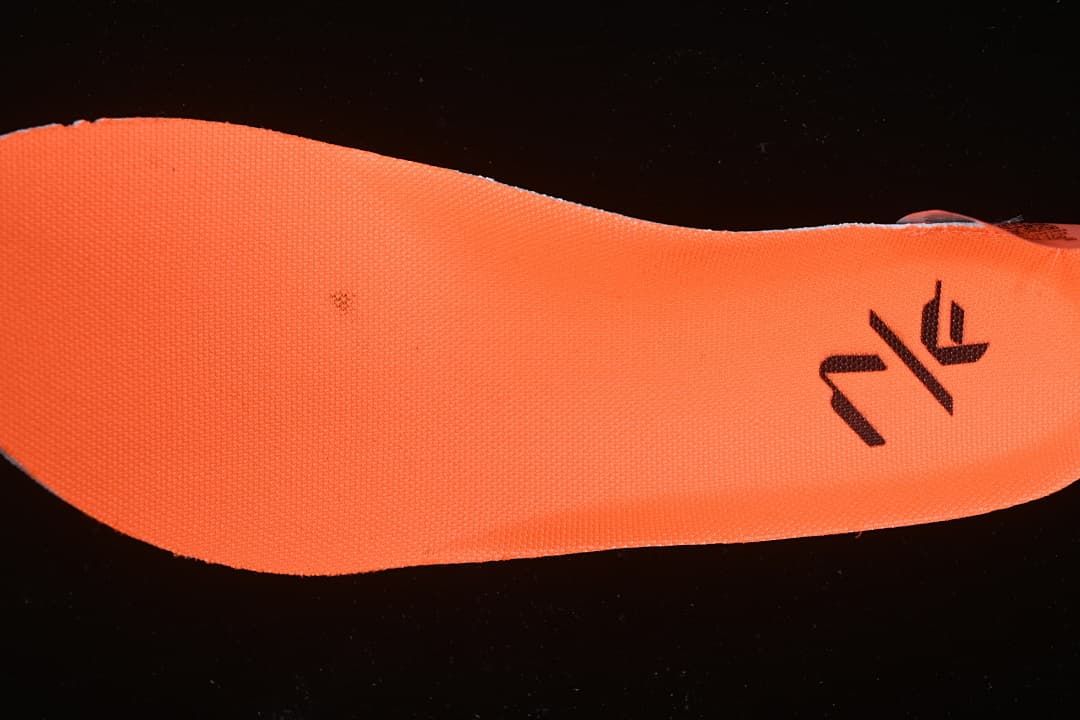 Close-up of a bright orange insole with a black graphic