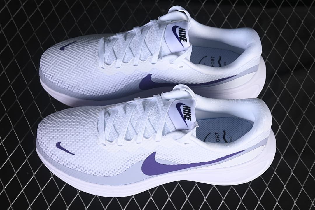 Pair of white Nike Revolution 8 shoes with purple accents