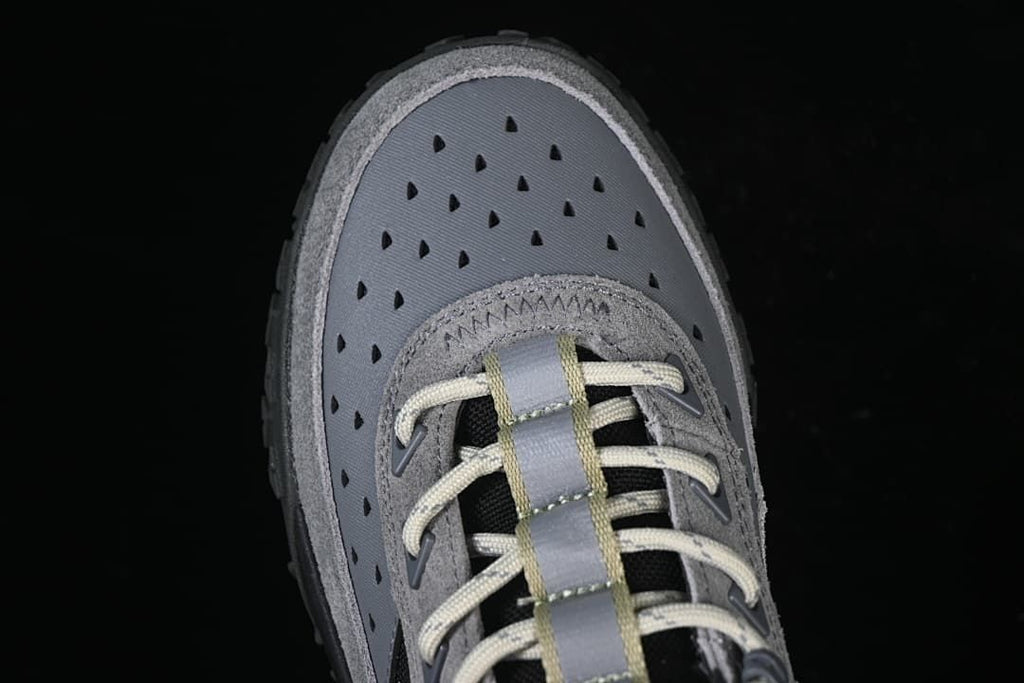 Top view of the perforated grey toe panel and laces.