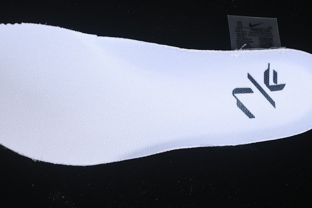 Close-up of the white knit-look upper, dark graphic and shoe label.