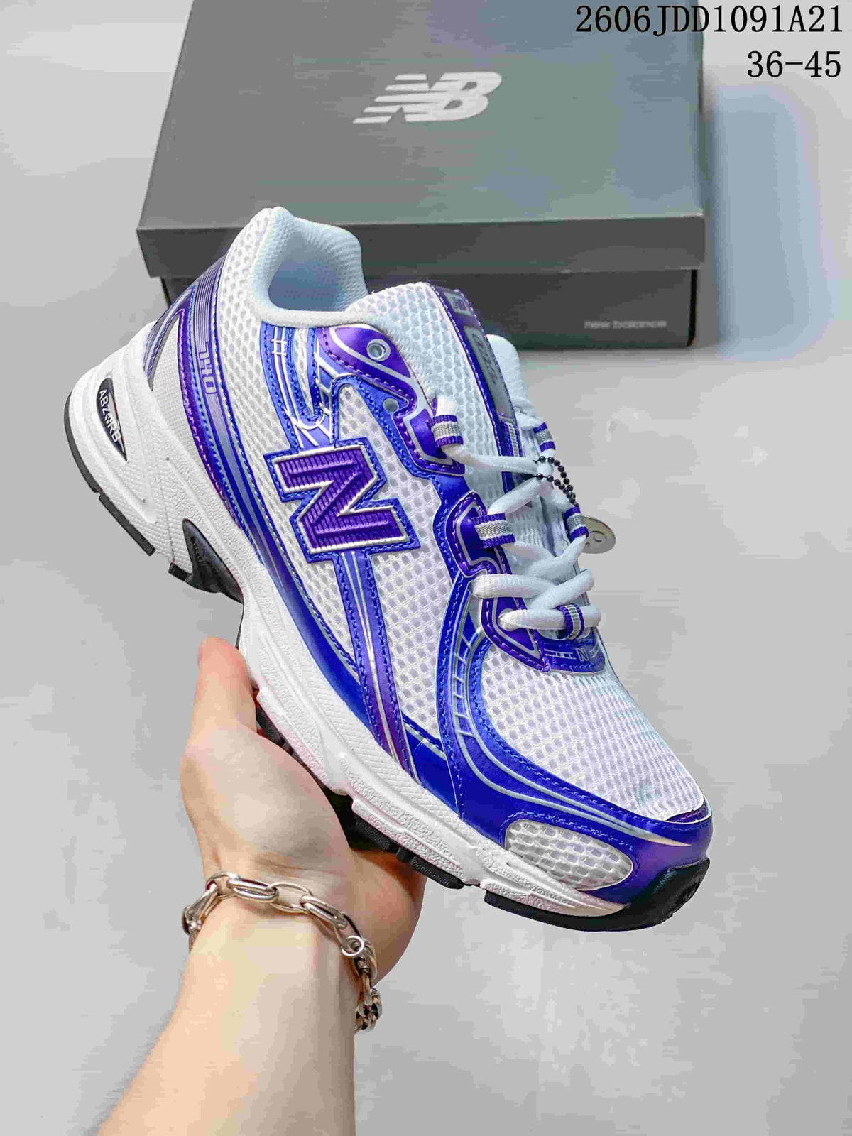 Angled side view of a white New Balance 740 sneaker with blue-purple details