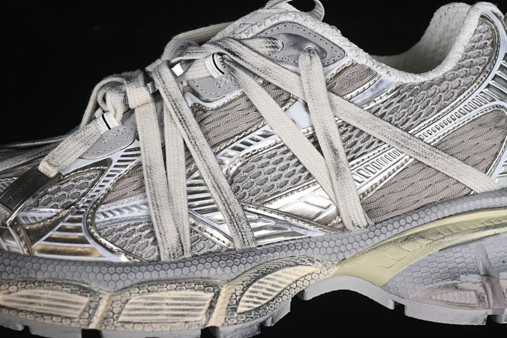 Close-up of the layered silver and grey side panels and laces