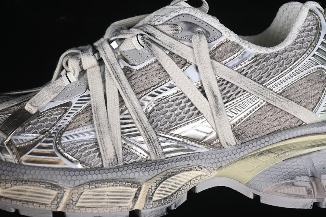 Close-up of the layered silver and grey side panels and laces