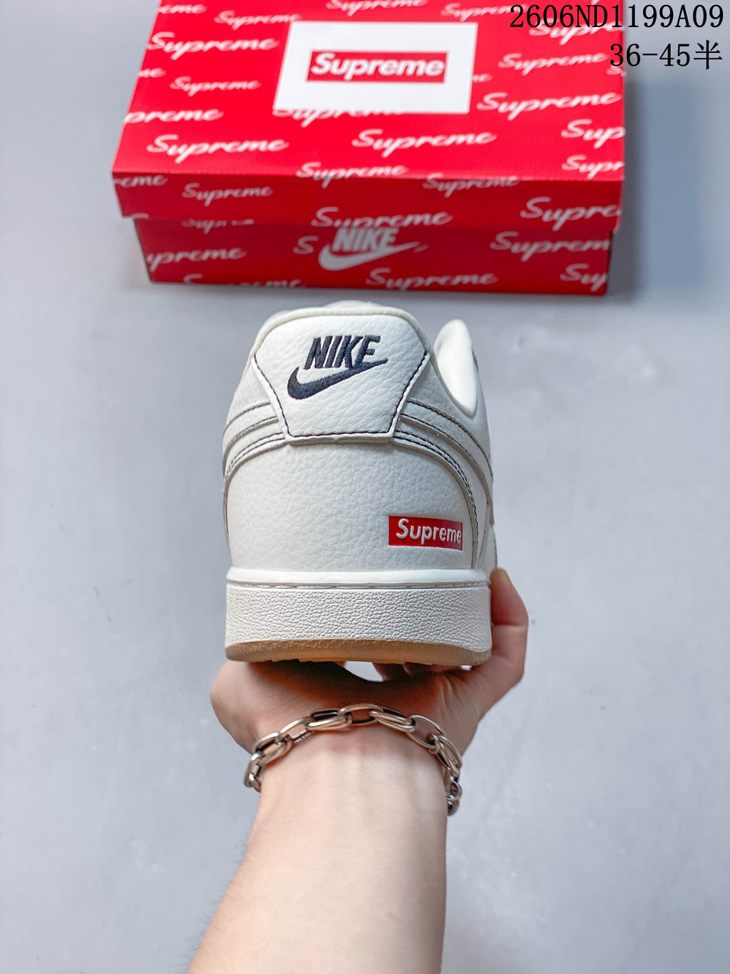 Rear view of the white sneaker showing Nike branding and a red heel detail.